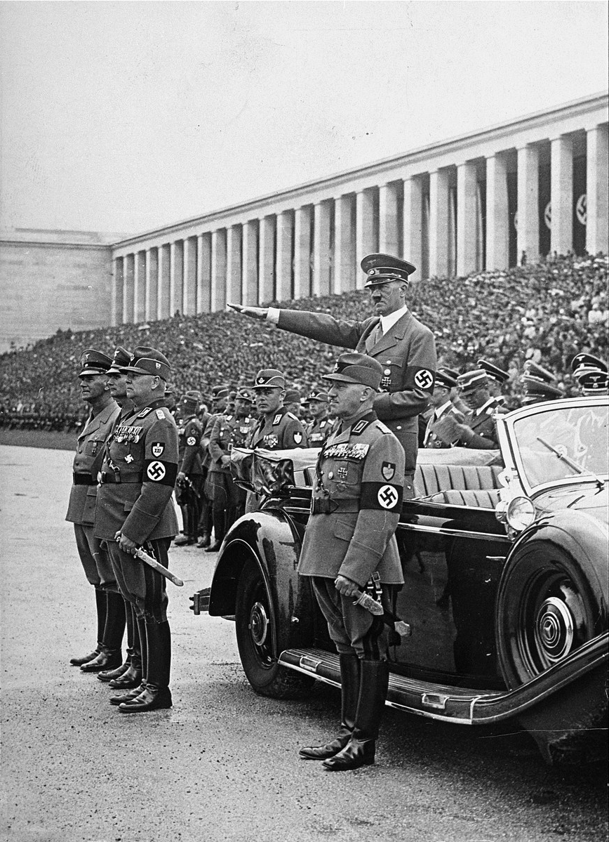 Formations of the Reich Labour Service parading past Adolf Hitler at the rally ground